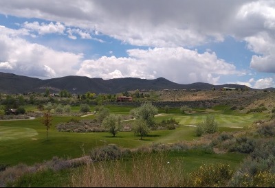 golf course green with mountains